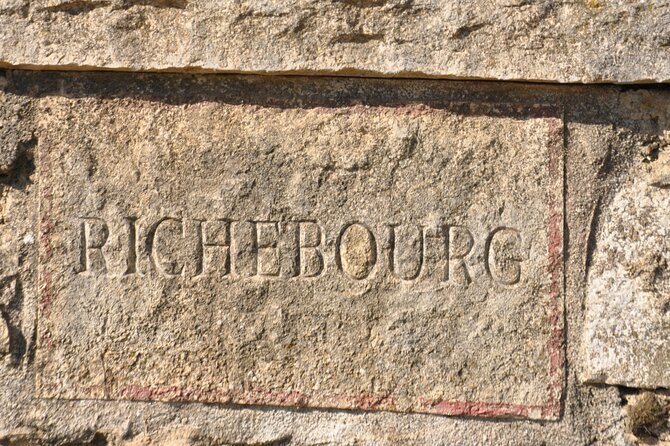 The name Richebourg cut into a block of weathered stone
